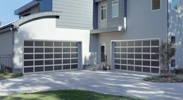 Amarr Vista full-view aluminium garage doors with frosted glass panels on a contemporary grey home