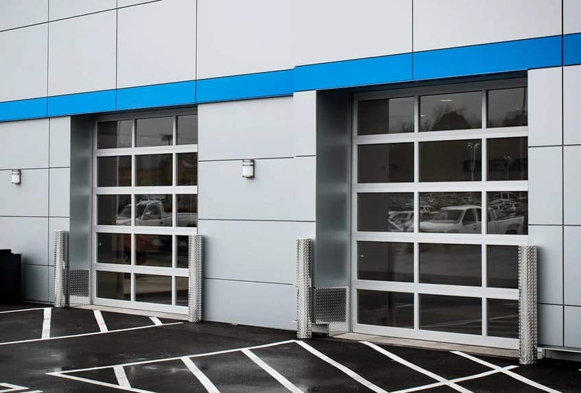 CHI full-view aluminum and glass garage doors on a commercial service building